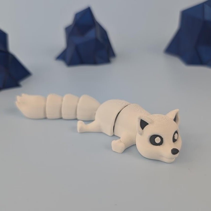 3D printed articulated arctic fox keychain figure with white coat, full side profile