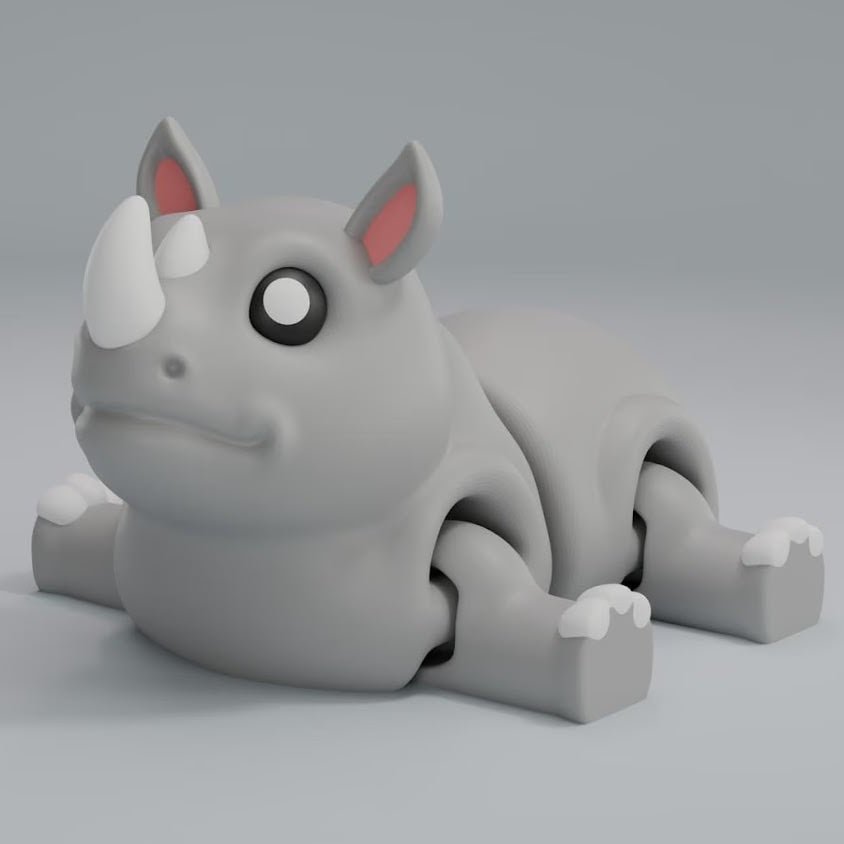 3D printed articulated rhino keychain figure with horn, full side profile
Rhino articulated figure posed, photographed in real setting
