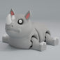 3D printed articulated rhino keychain figure with horn, full side profile
Rhino articulated figure posed, photographed in real setting
