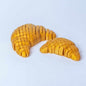 Articulated 3D printed Floppy Croissant fidget toy with flexible bending body
Floppy Croissant toy held to show its wiggly, poseable golden-brown segments