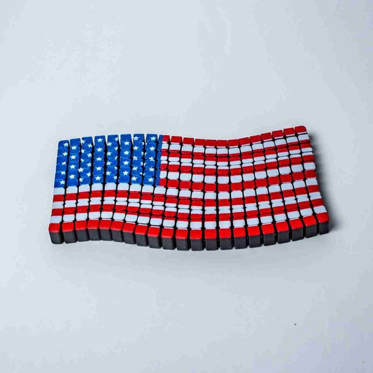 3D printed wavy American flag desk décor piece with rippled Stars and Stripes
Flappy American flag 3D print shown from an angle, highlighting the fluttering texture