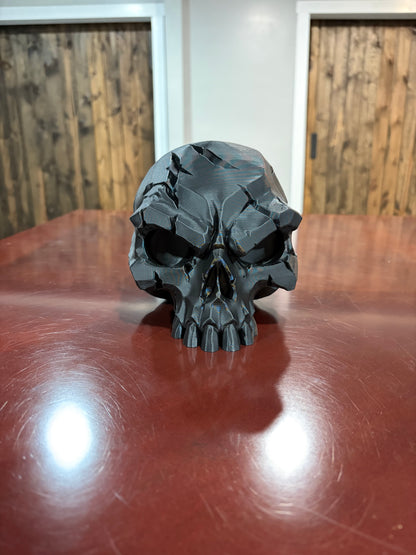 Black 3D printed battle scar skull display piece, front view
