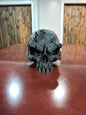 Black 3D printed battle scar skull display piece, front view
