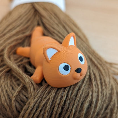 Orange 3D printed articulated cat keychain figure, side view