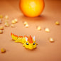 3D-printed Sun Dragon articulated flexi in warm sun-yellow, front view posed standing — 864 ToyLabs
