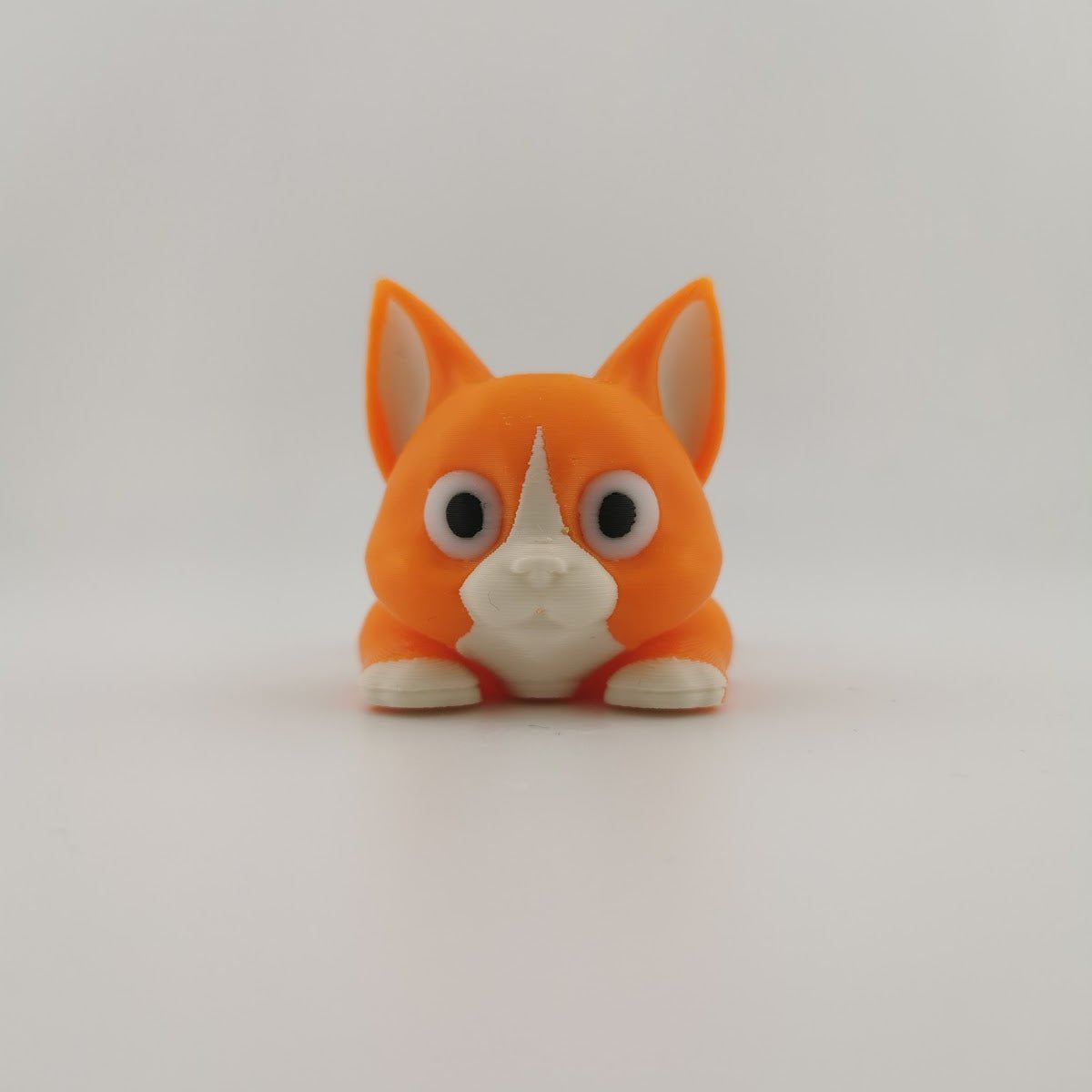 3D printed articulated flexi cat figure standing, side view

