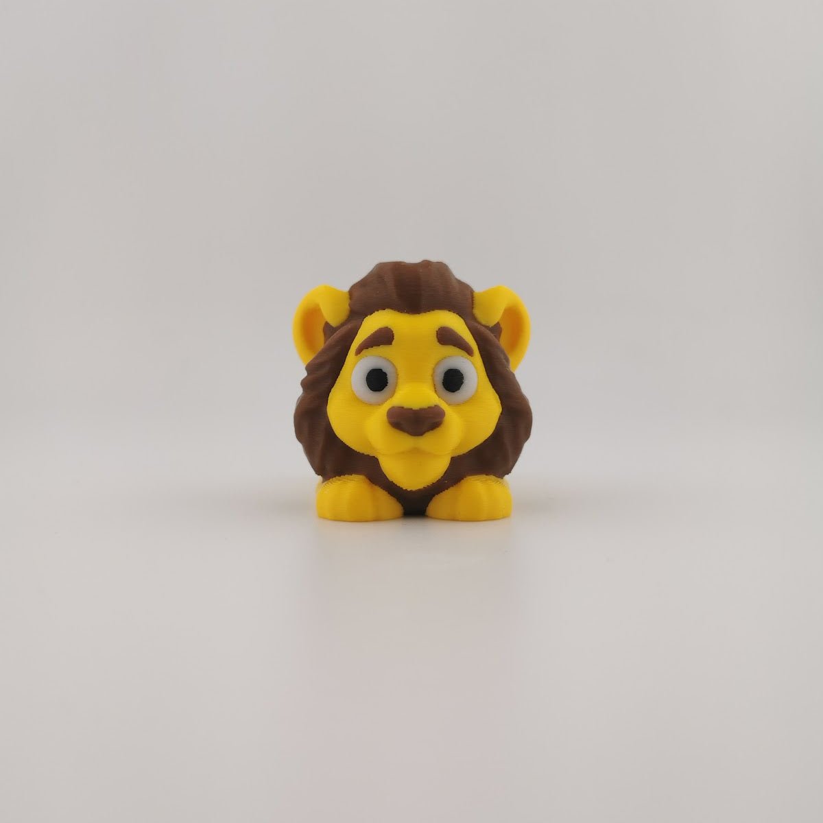 Articulated lion figure posed with body curved, showing flexible joints