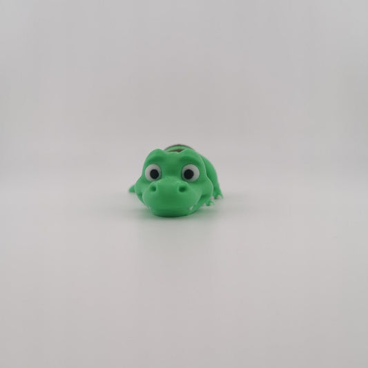 Green 3D printed articulated T-Rex dinosaur figure, side view
