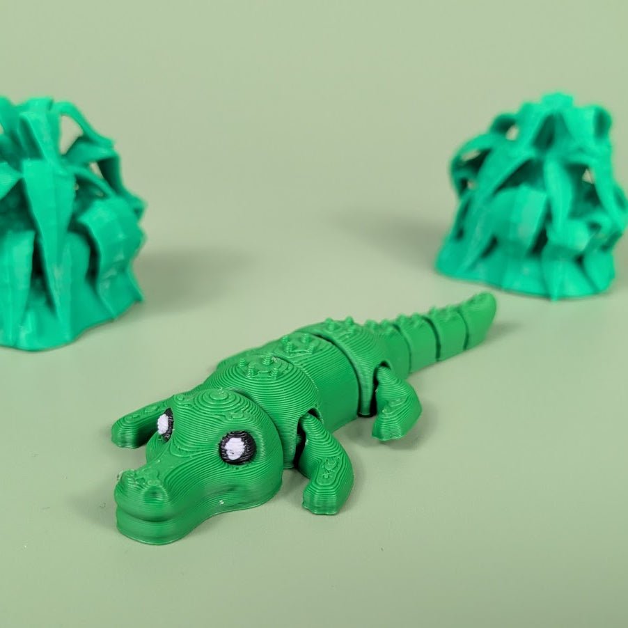 Articulated 3D printed Crocodile figure shown in side profile with textured scales
Crocodile figure posed to show its bending, segmented body
