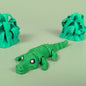 Articulated 3D printed Crocodile figure shown in side profile with textured scales
Crocodile figure posed to show its bending, segmented body
