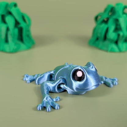 Articulated 3D printed Poison Dart Frog with bold rainforest coloring, top view
Poison Dart Frog figure posed to show its bending, flexible joints
